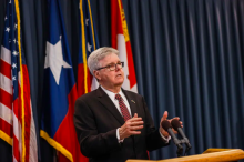 Dan Patrick speaks to reporters at a press conference