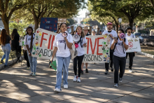 Members of the Finish the 5 Coalition march to the Texas Capitol. Photo by Sergio Flores for The Texas Tribune