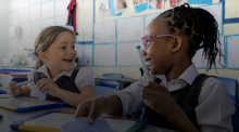 Video screengrab of two students smiling at each other